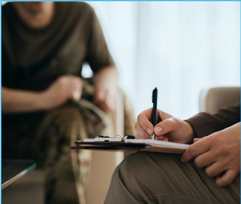 A close-up of a hand writing the words “HYPNOTHERAPY FOR DEPENDENCY” on a piece of paper.