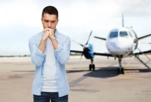 Person experiencing fear of flying, symbolizing therapy and support for flight anxiety at Natural Healing Clinic