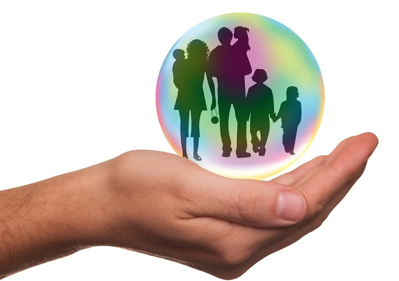 Hand supporting a family of father, mother, and children, symbolizing family therapy and support at Natural Healing Clinic